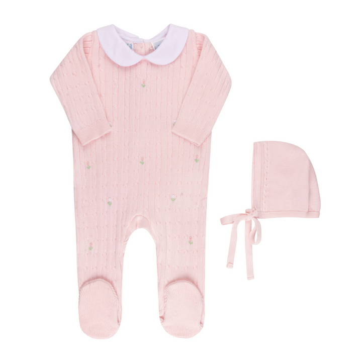 Pink baby romper with white collar and matching bonnet on a white background