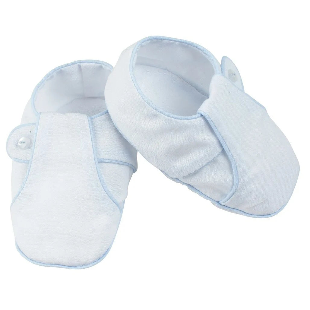 Pair of white baby shoes with blue trim on a white background