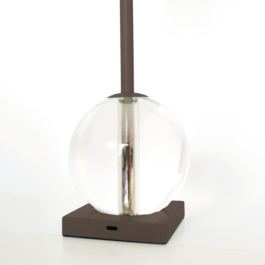 Modern pendant light with clear glass shade and brown base on a white background
