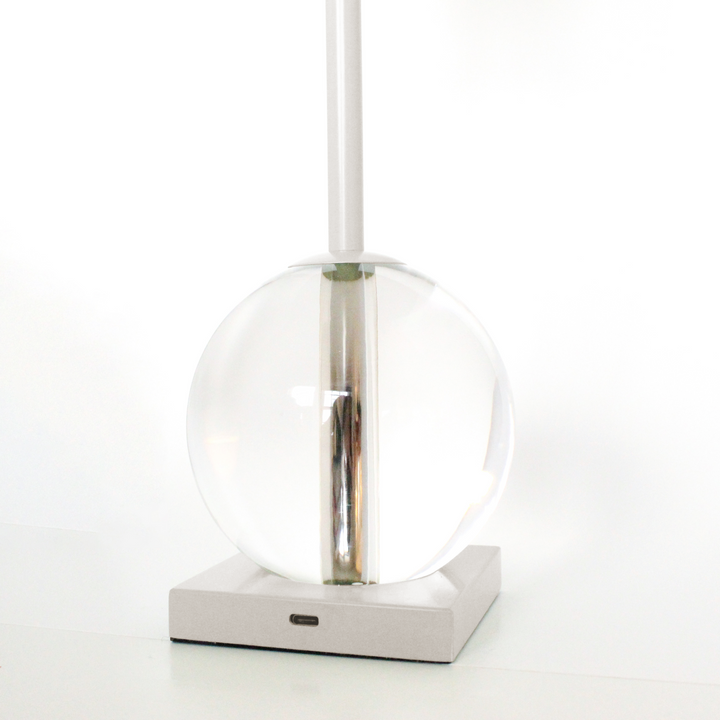 Modern pendant light with clear glass shade and metallic fixture on a white background