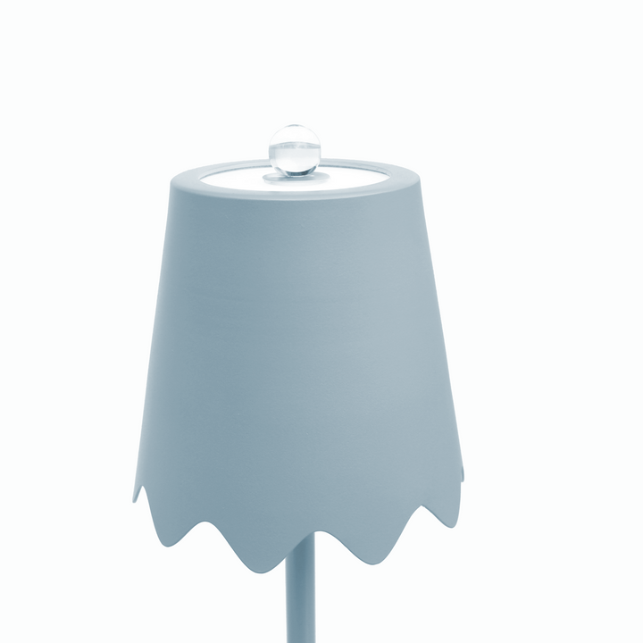 Light blue ceramic vase with scalloped edge on a white background