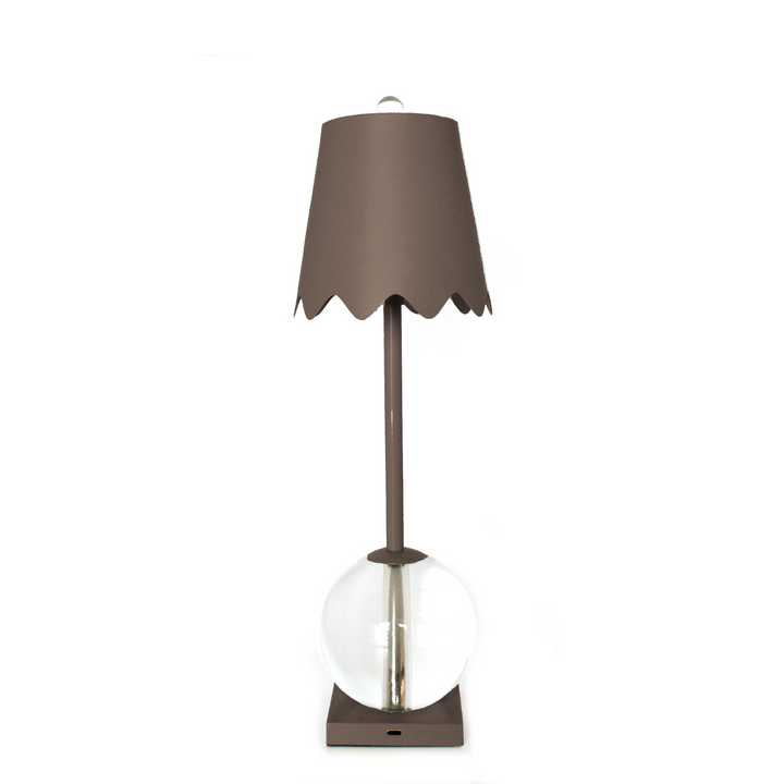 Table lamp with a brown shade and clear glass base on a white background