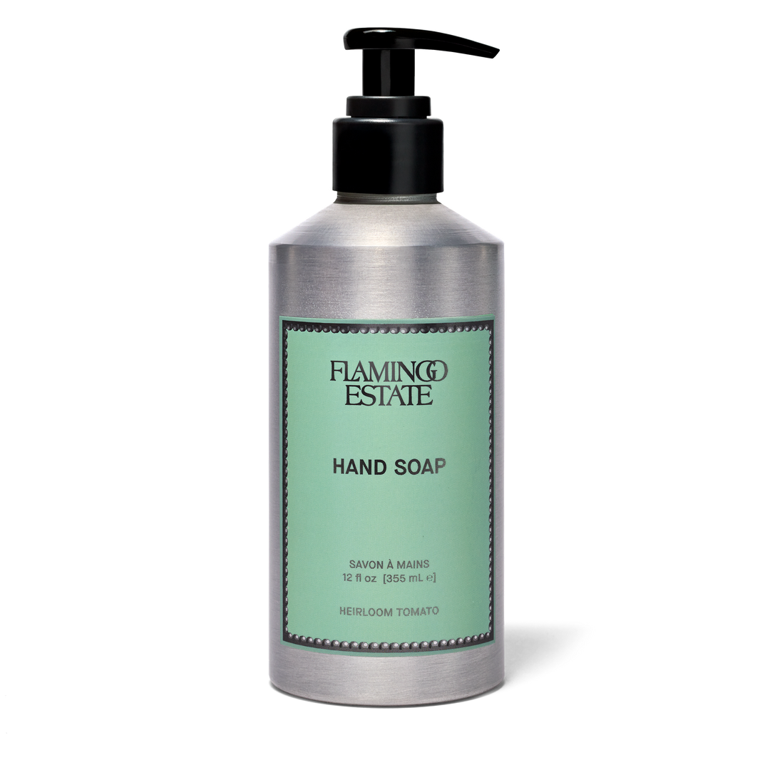 A silver pump bottle of Flamingo Estate Hand Soap with a black dispenser and a light green label, set against a plain white background.