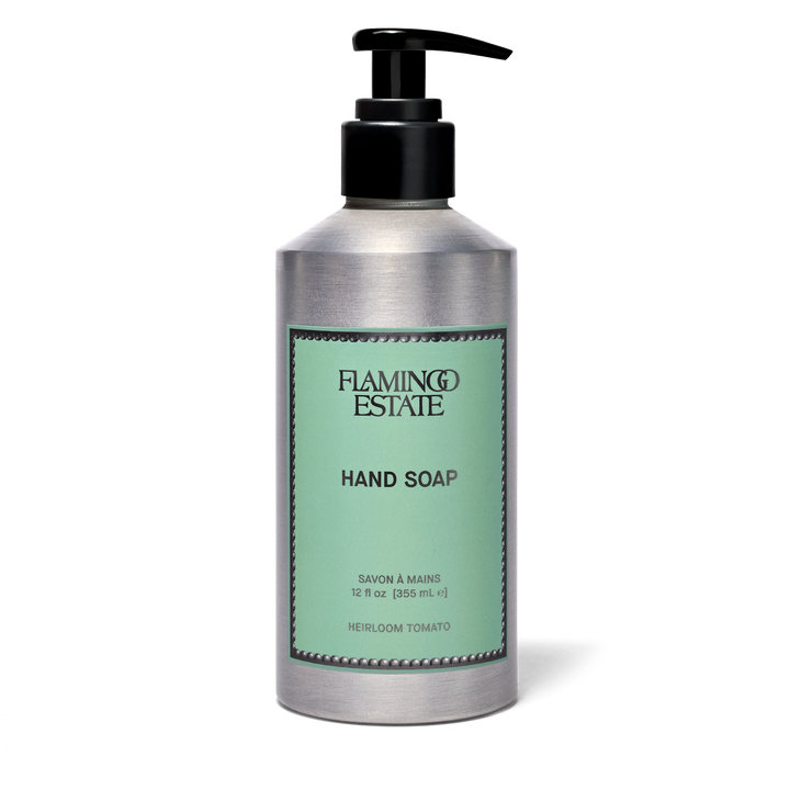 A silver pump bottle of Flamingo Estate Hand Soap with a black dispenser and a light green label, set against a plain white background.