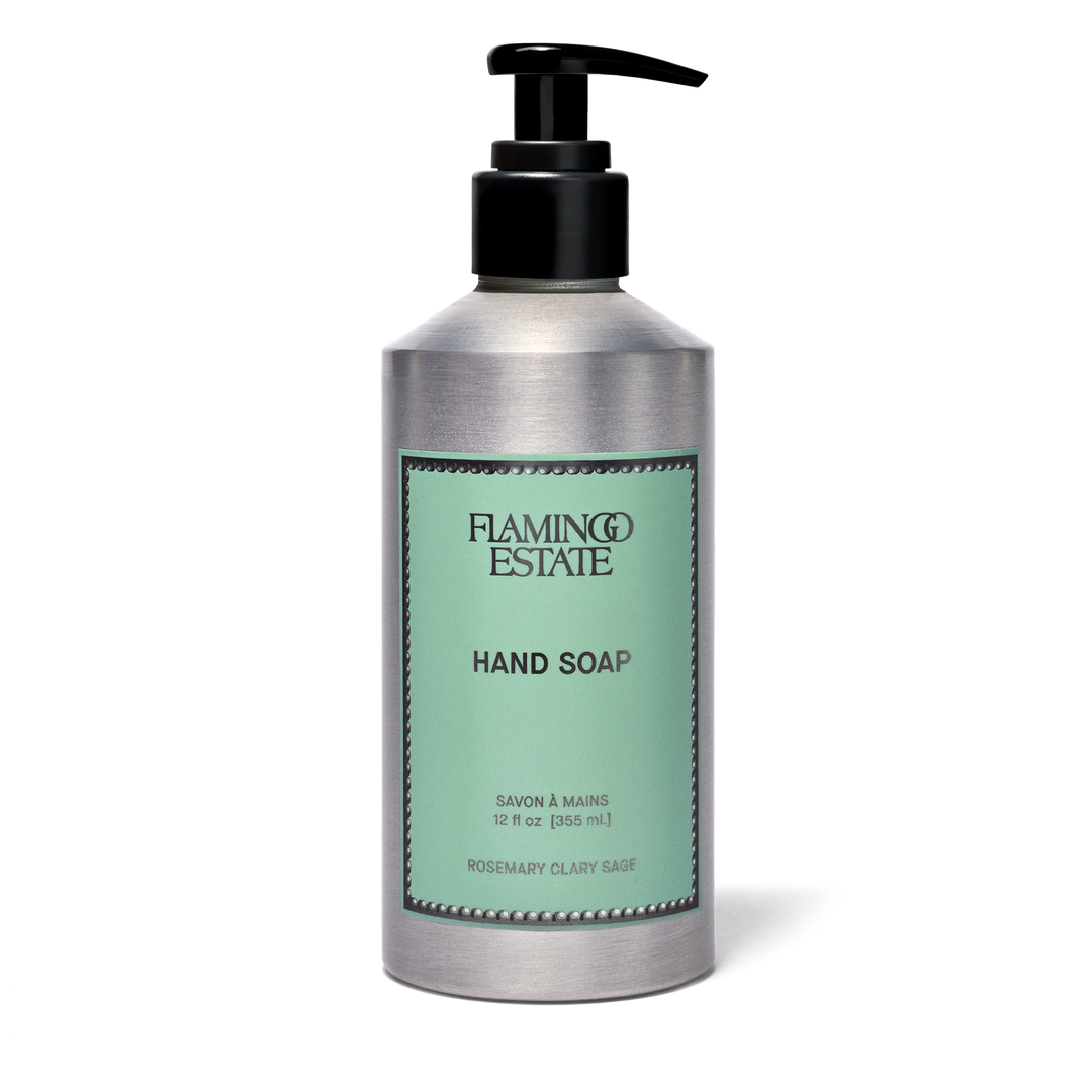 A silver pump bottle of Flamingo Estate Hand Soap on a white background. The bottle has a black pump and a mint green label with black text.