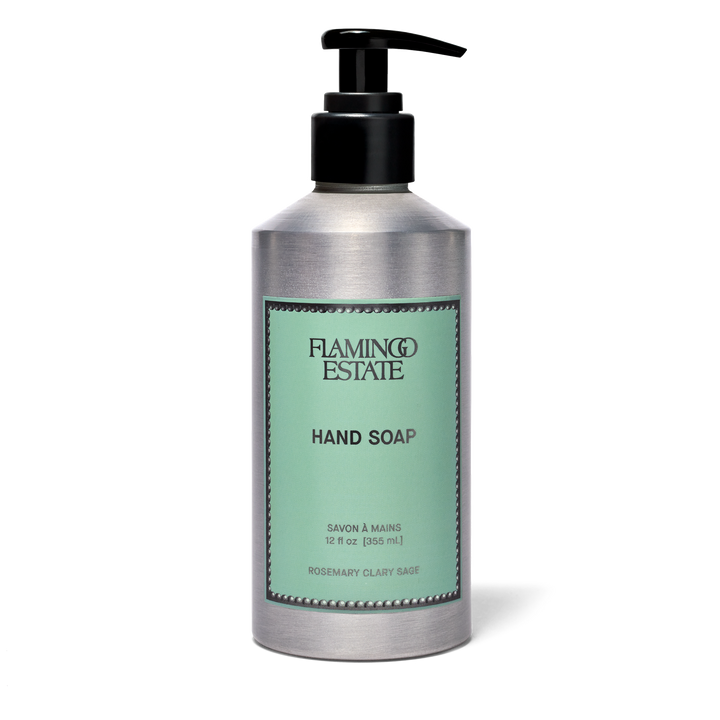 A silver pump bottle of Flamingo Estate Hand Soap on a white background. The bottle has a black pump and a mint green label with black text.