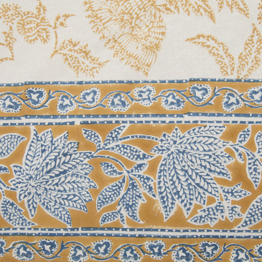 Patterned fabric with blue and gold floral design on a white background