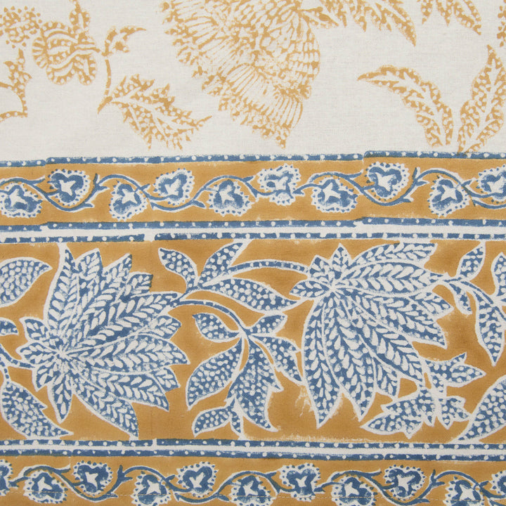 Patterned fabric with blue and gold floral design on a white background