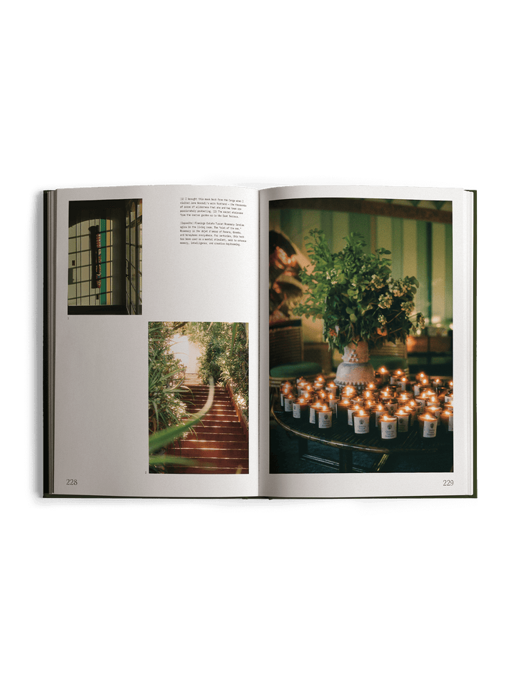 Open book showing interior design images with plants and candles.