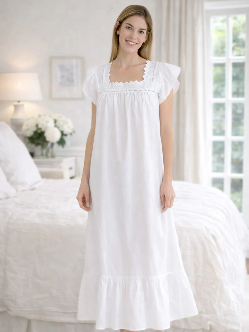 Woman wearing a white nightgown in a bedroom setting