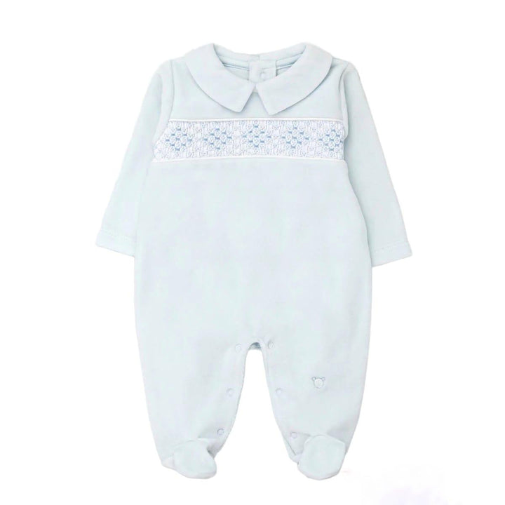 A baby long-sleeve footed romper in pale icy blue, featuring a Peter Pan collar and a smocked chest panel with blue hearts and white dots.