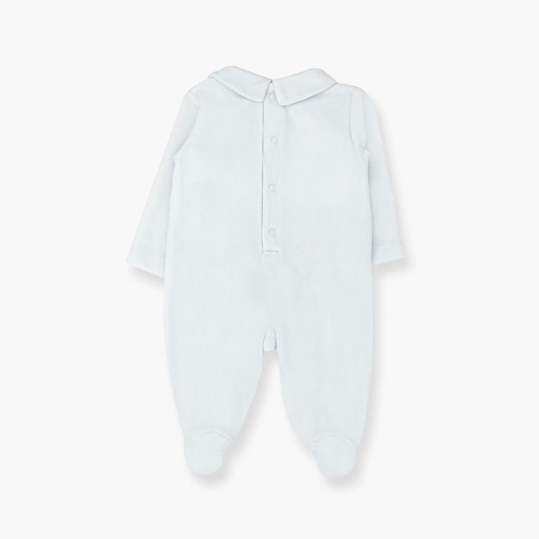 A light blue long-sleeve baby footed jumpsuit with a short collar and snap button closure, shown flat on a white background.
