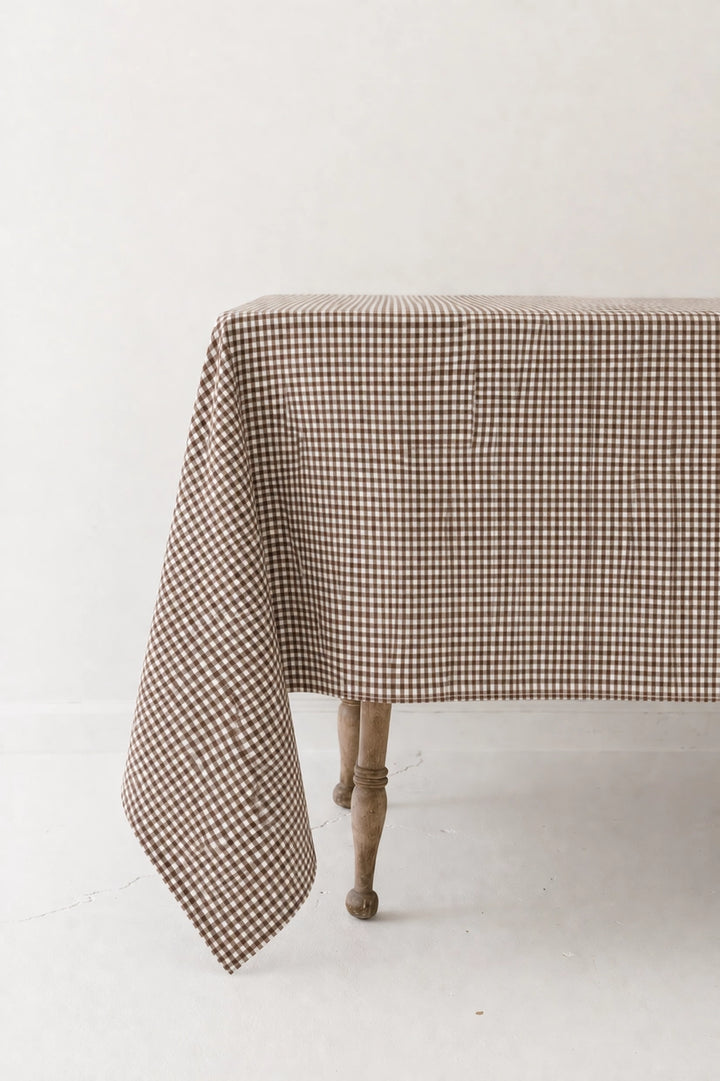 Checkered tablecloth on a wooden table against a white background