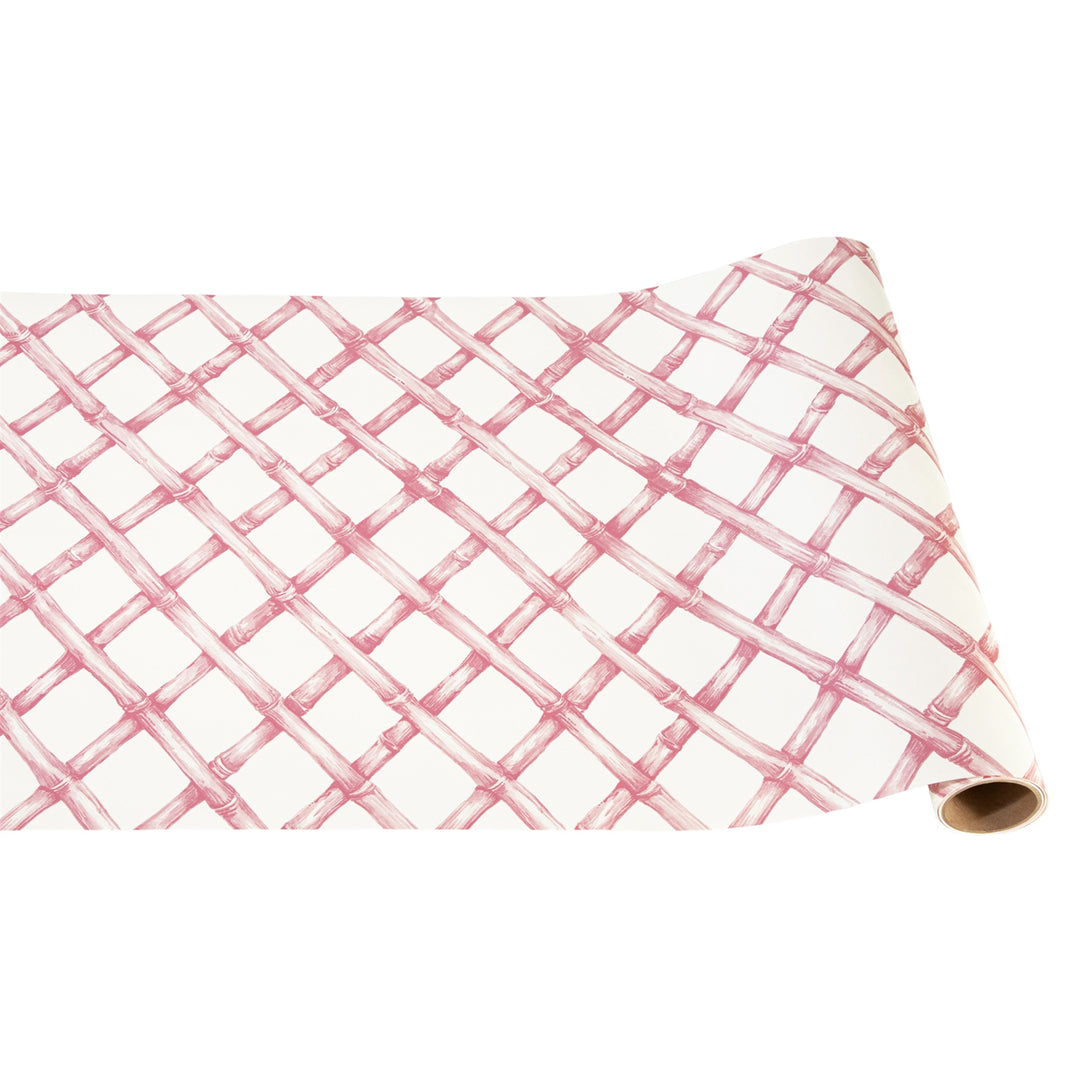 Roll of pink and white checkered paper on a white background
