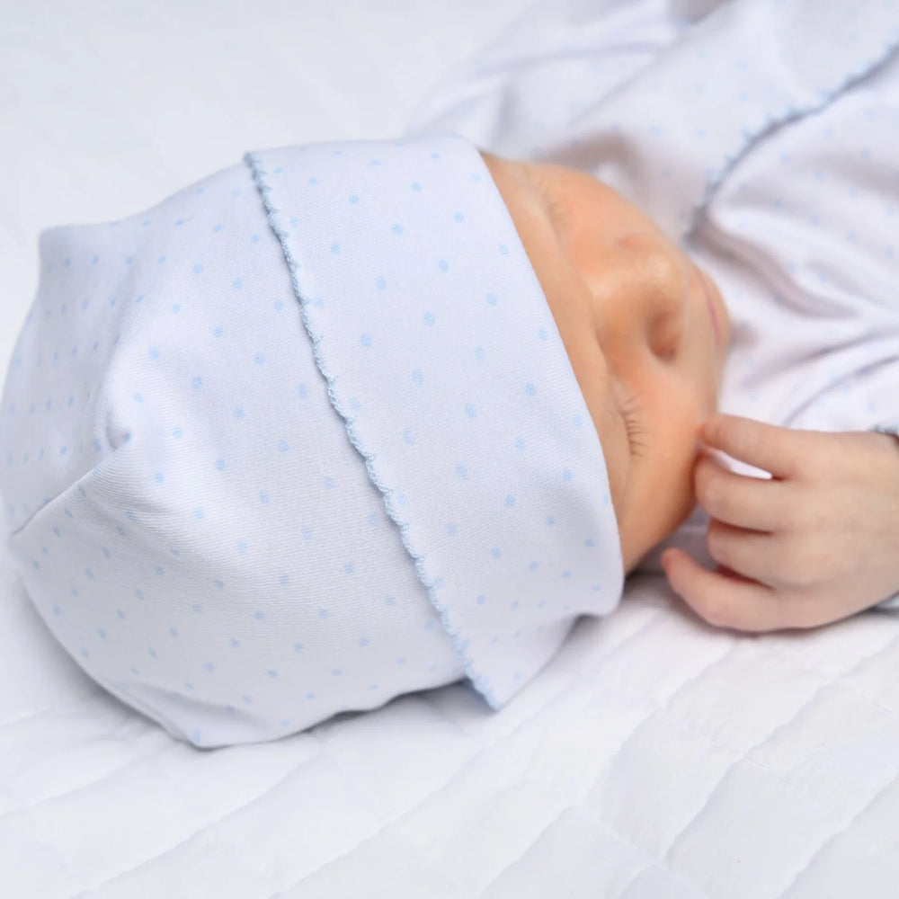 Baby wearing a light blue outfit with a white background
