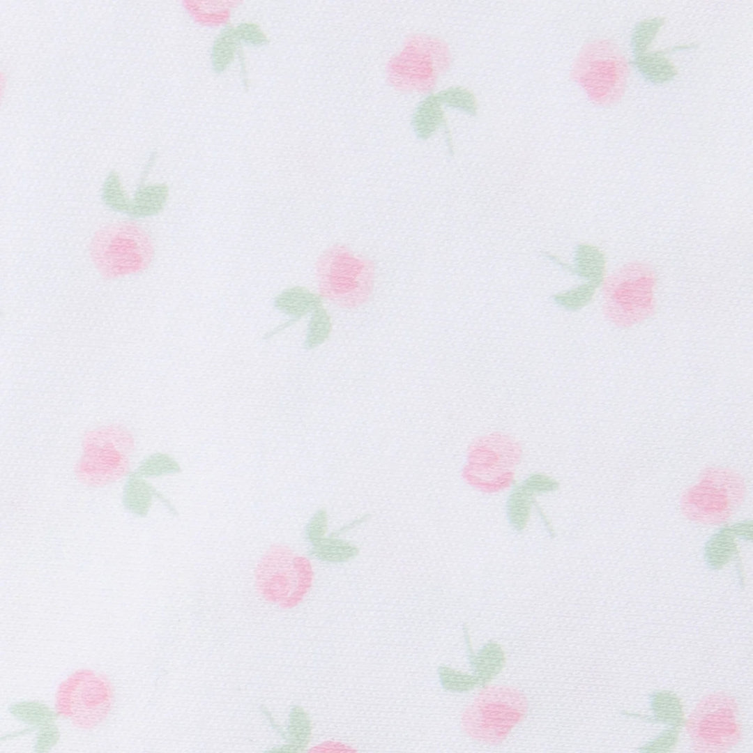 up close view of white fabric with pink floral print