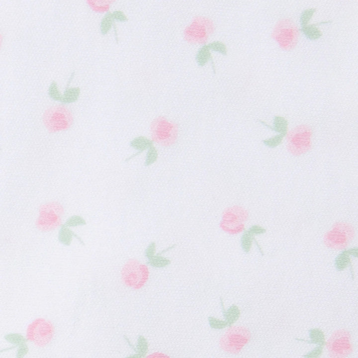 up close view of white fabric with pink floral print