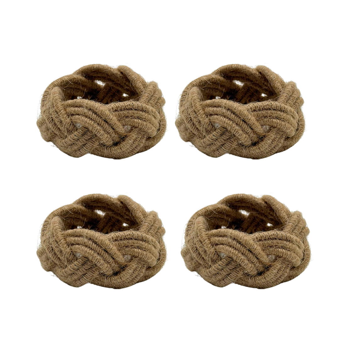 Four braided napkin rings made of a textured material on a white background