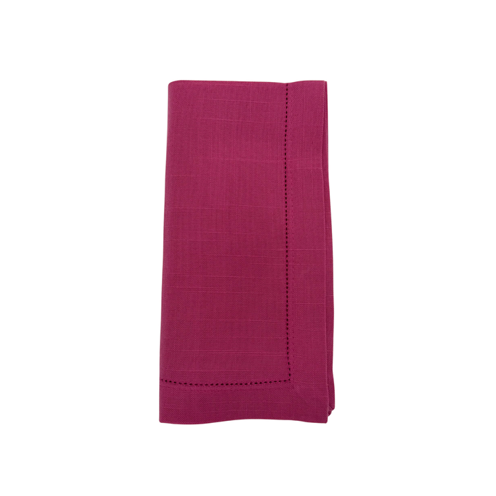 Folded magenta napkin on a white background