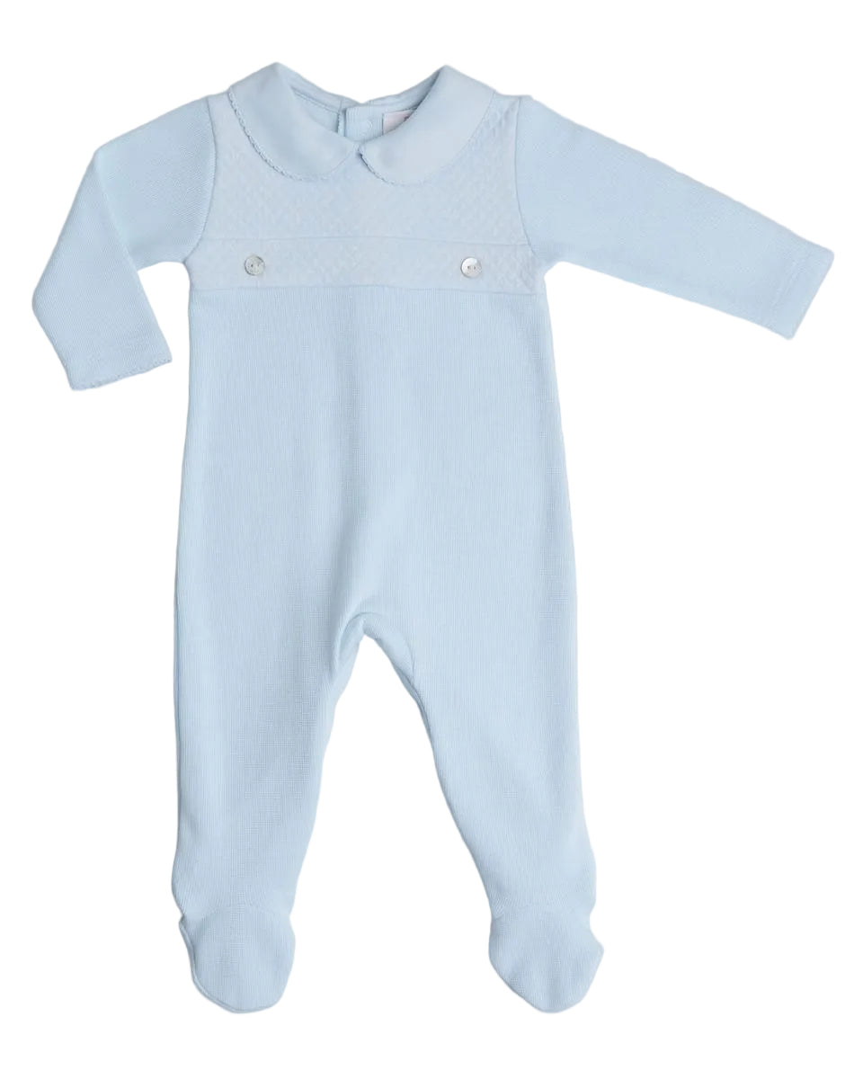 A baby's long-sleeve footed sleeper in light blue, featuring a Peter Pan collar, a textured yoke with two silver snap buttons, and cuffed ankles, shown flat on a neutral gray background.