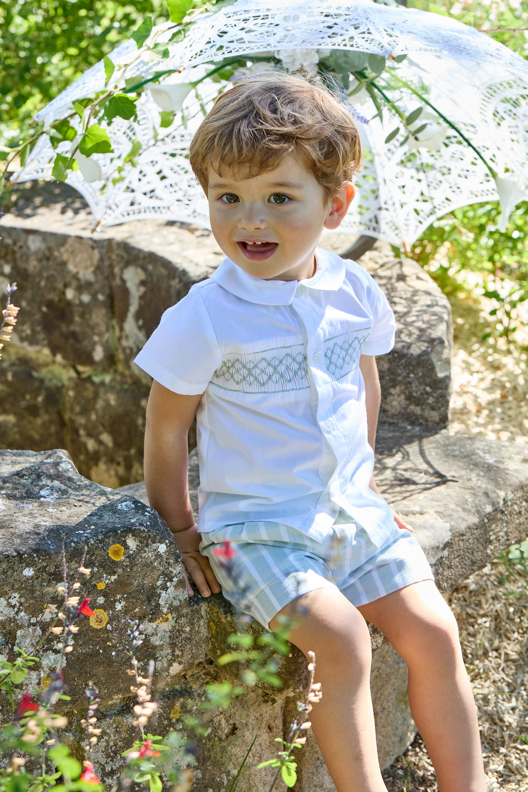 Toddler Boy wearing Smocked Outfit Sitting Outside