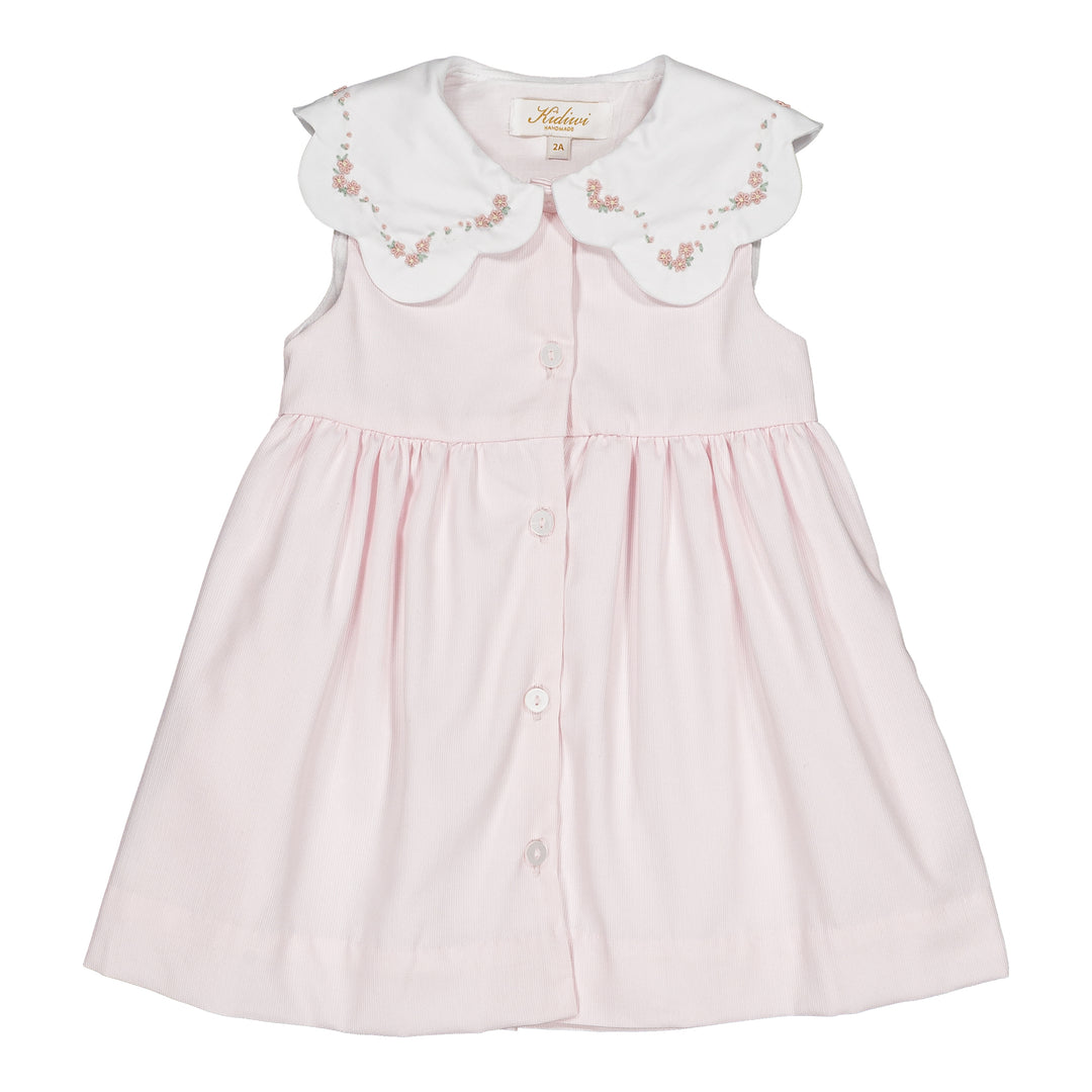 Pink dress with embroidered collar on a white background