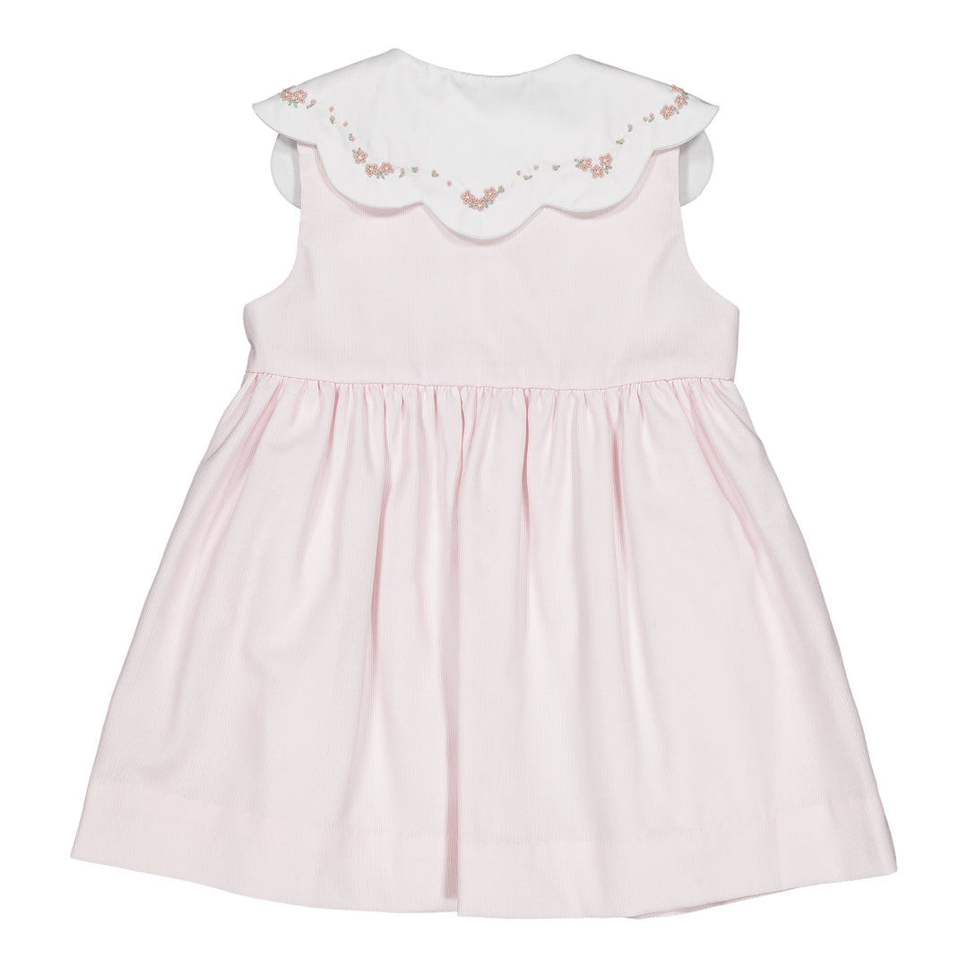 Pink dress with floral embroidery on a white background
