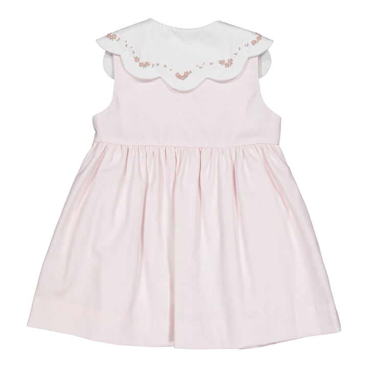 Pink dress with floral embroidery on a white background