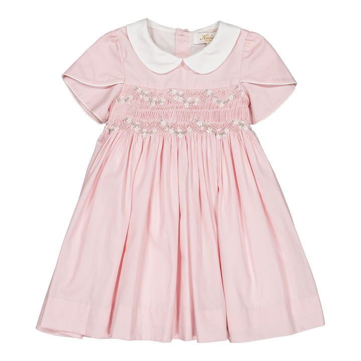 Pink dress with white collar on a white background