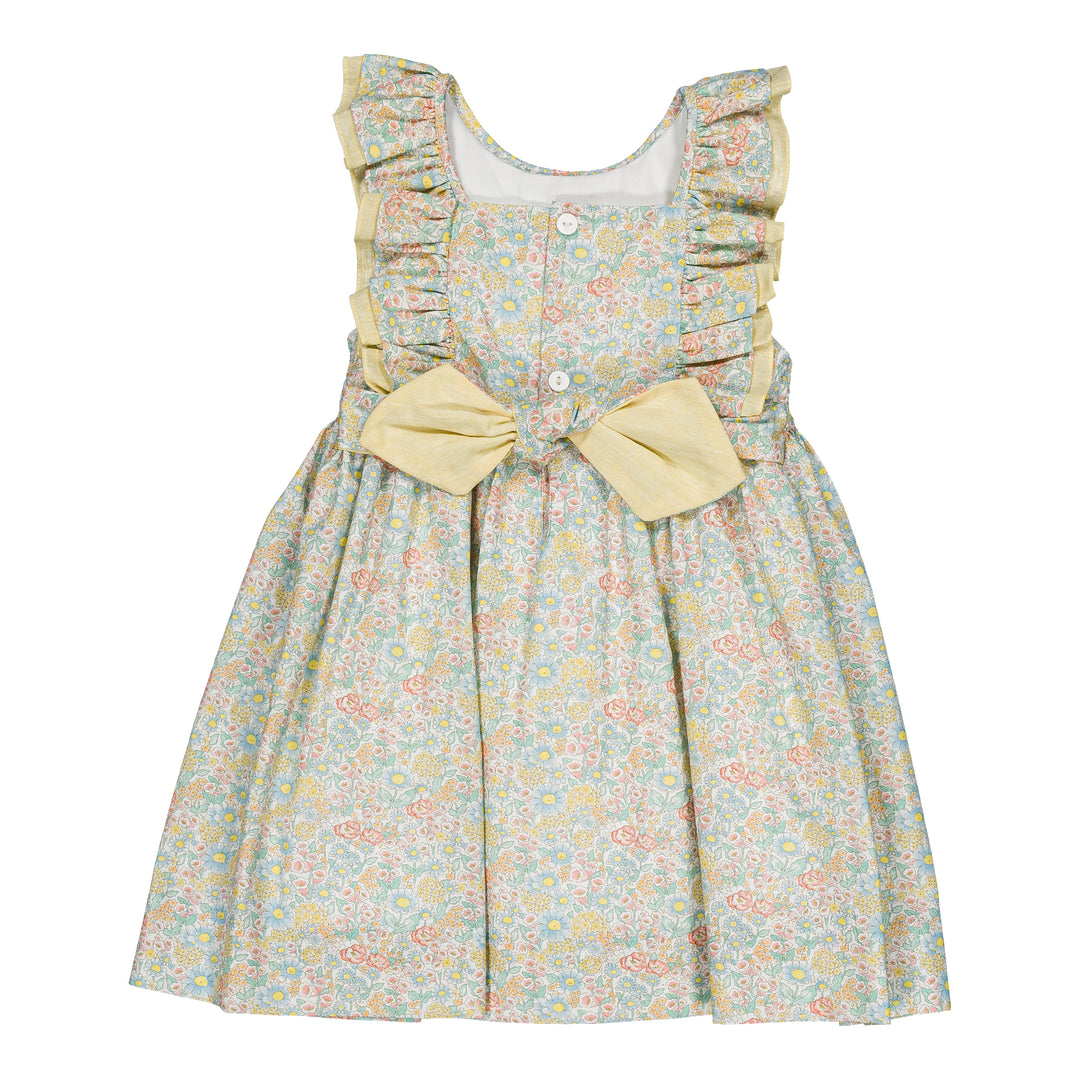 Floral dress with ruffled sleeves and a bow on a white background