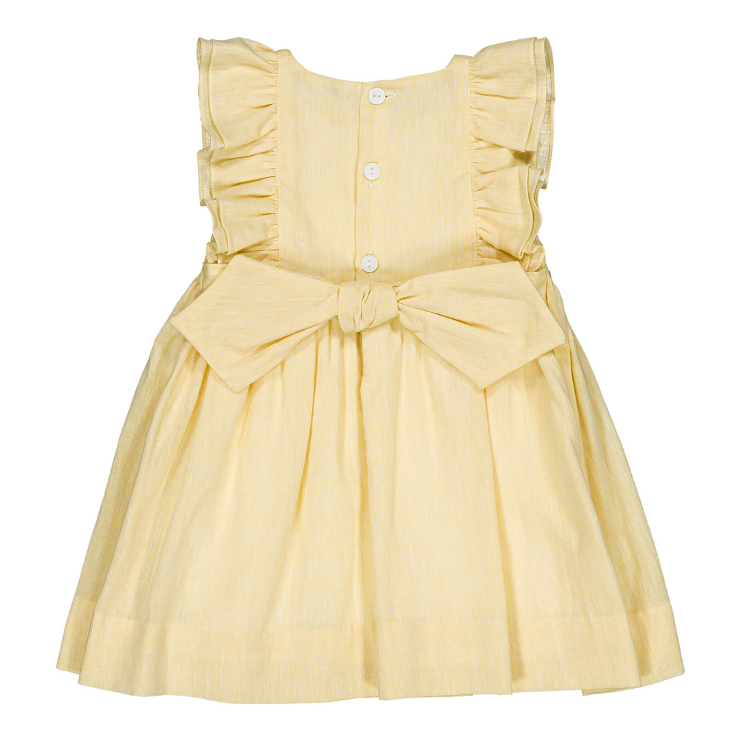 Yellow dress with ruffled straps and a bow on a white background