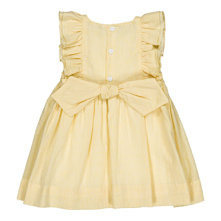 Yellow dress with ruffled straps and a bow on a white background