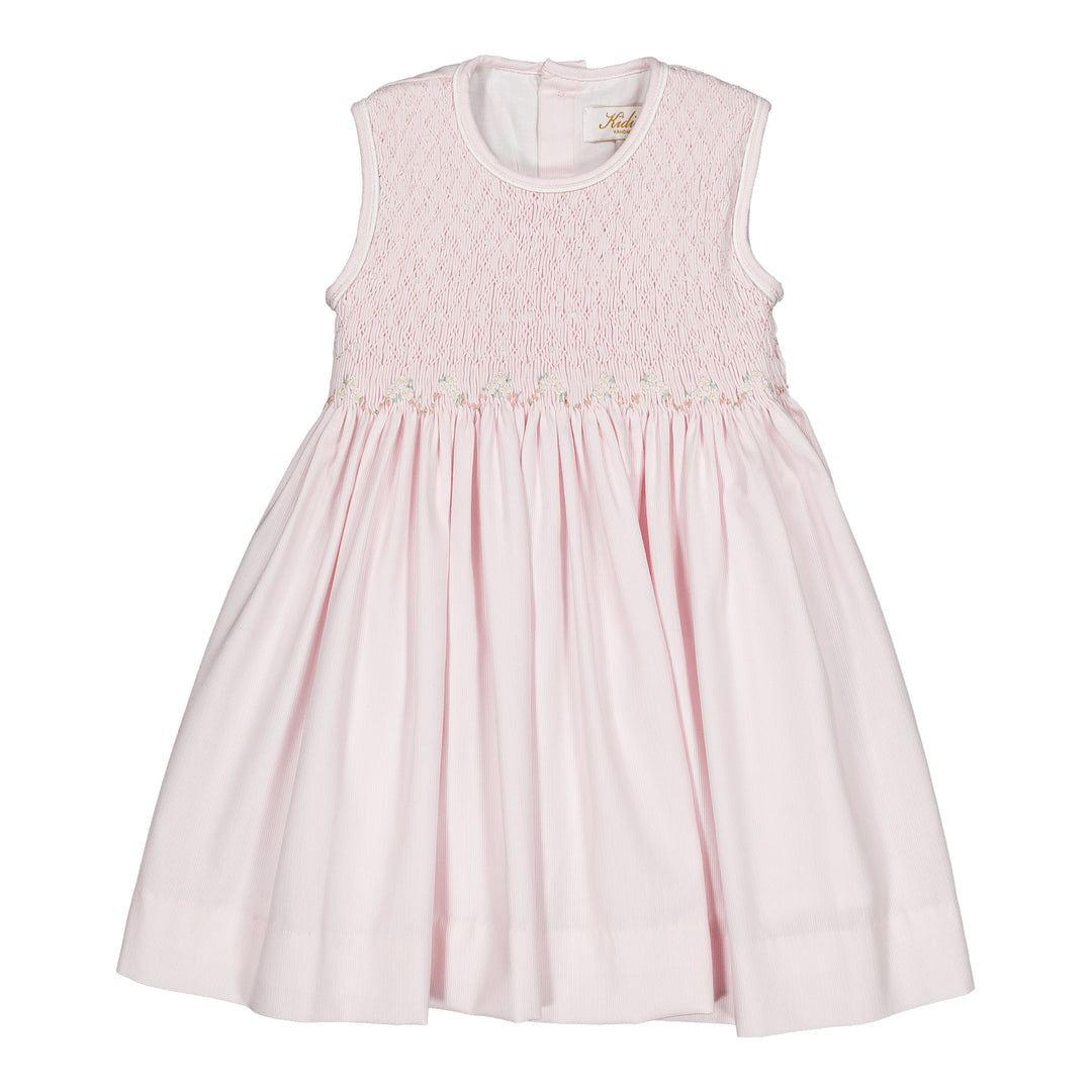 Pink dress with smocked details on a white background