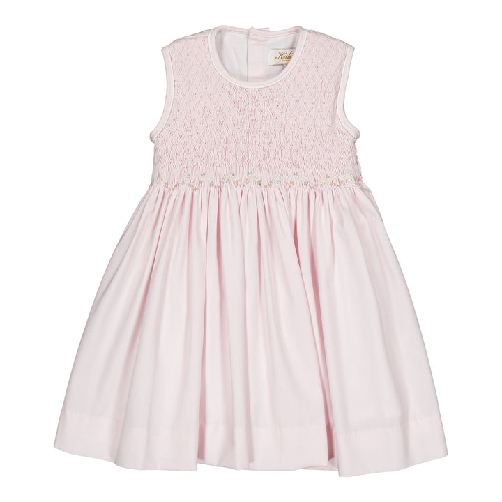 Pink dress with smocked details on a white background