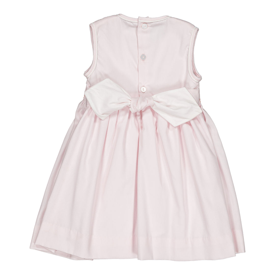 Pink dress with a large white bow on a white background