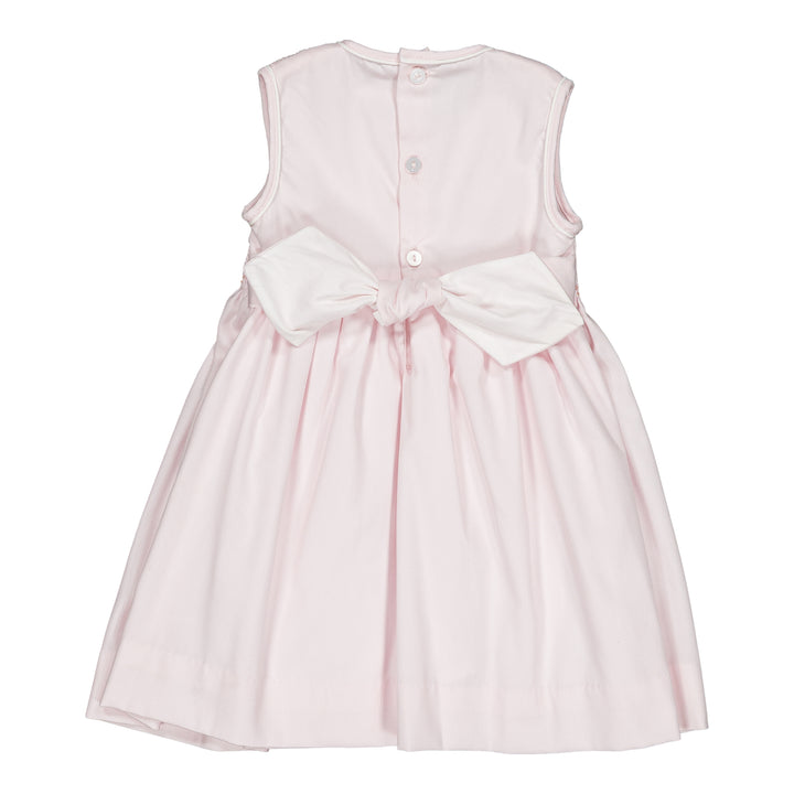 Pink dress with a large white bow on a white background