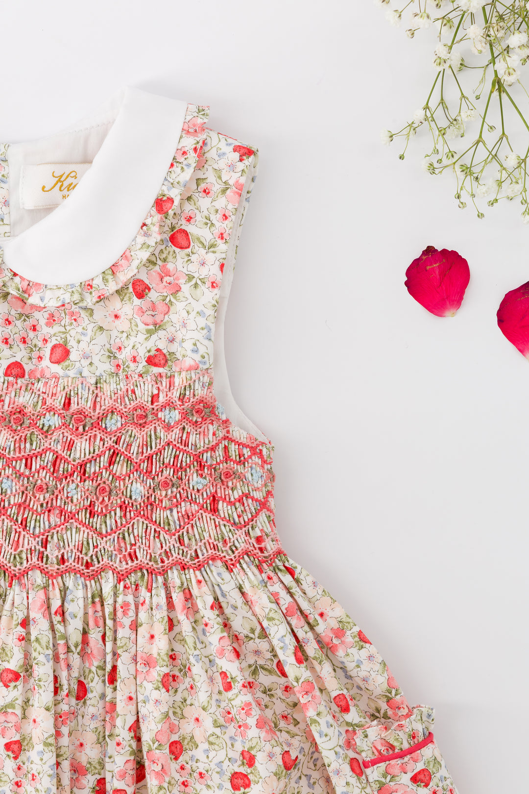 Floral dress with red accents on a white background