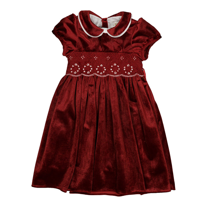 A girl's burgundy velvet dress with a Peter Pan collar, white trim, and a smocked bodice with embroidered details.