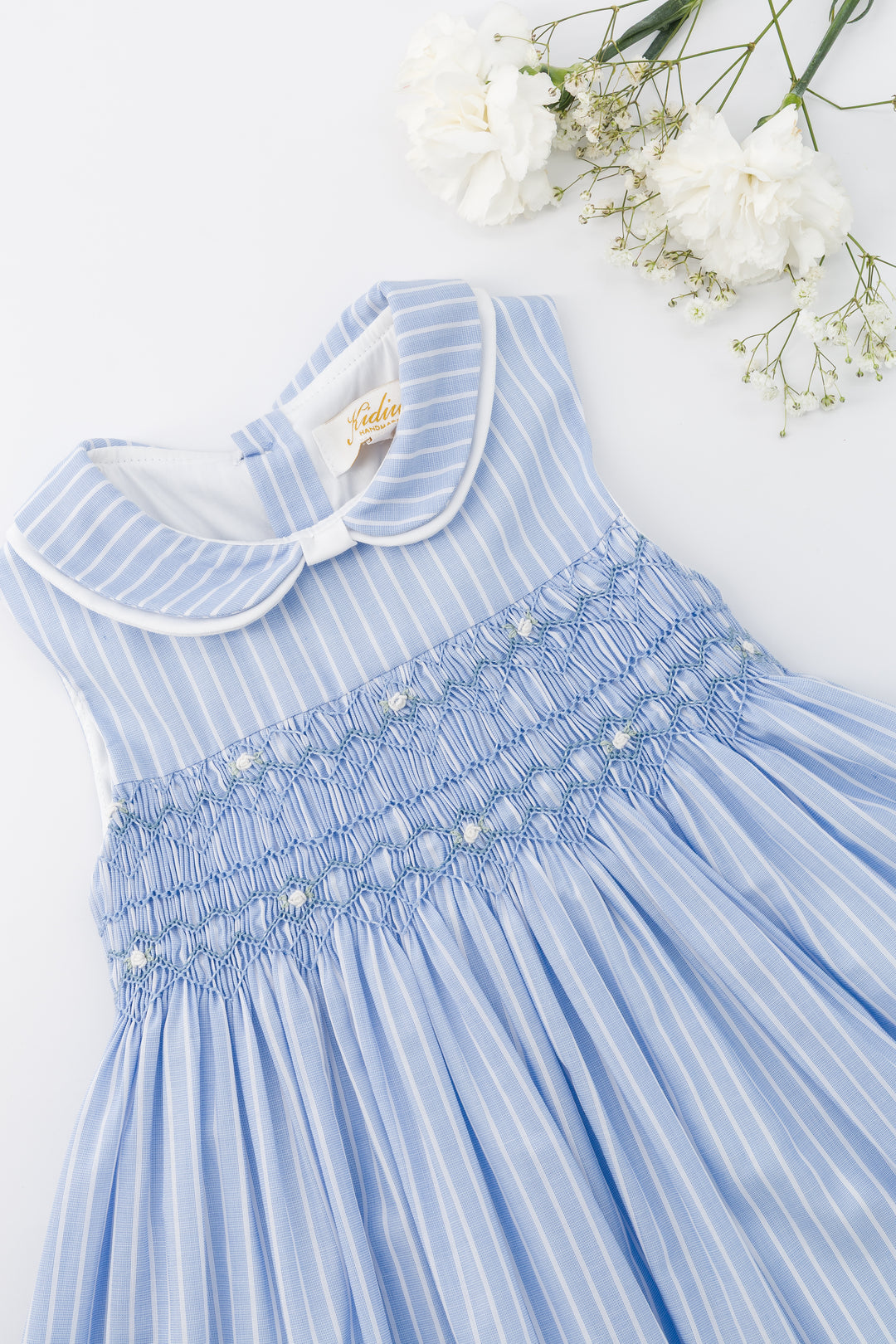Blue dress with white collar on a white background