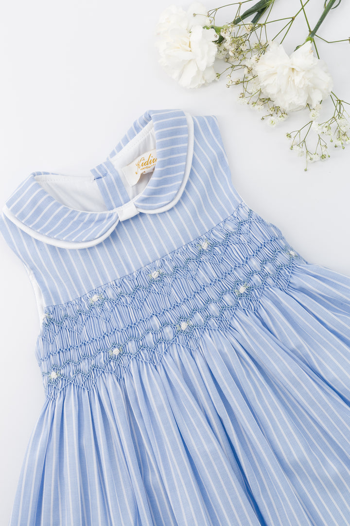 Blue dress with white collar on a white background