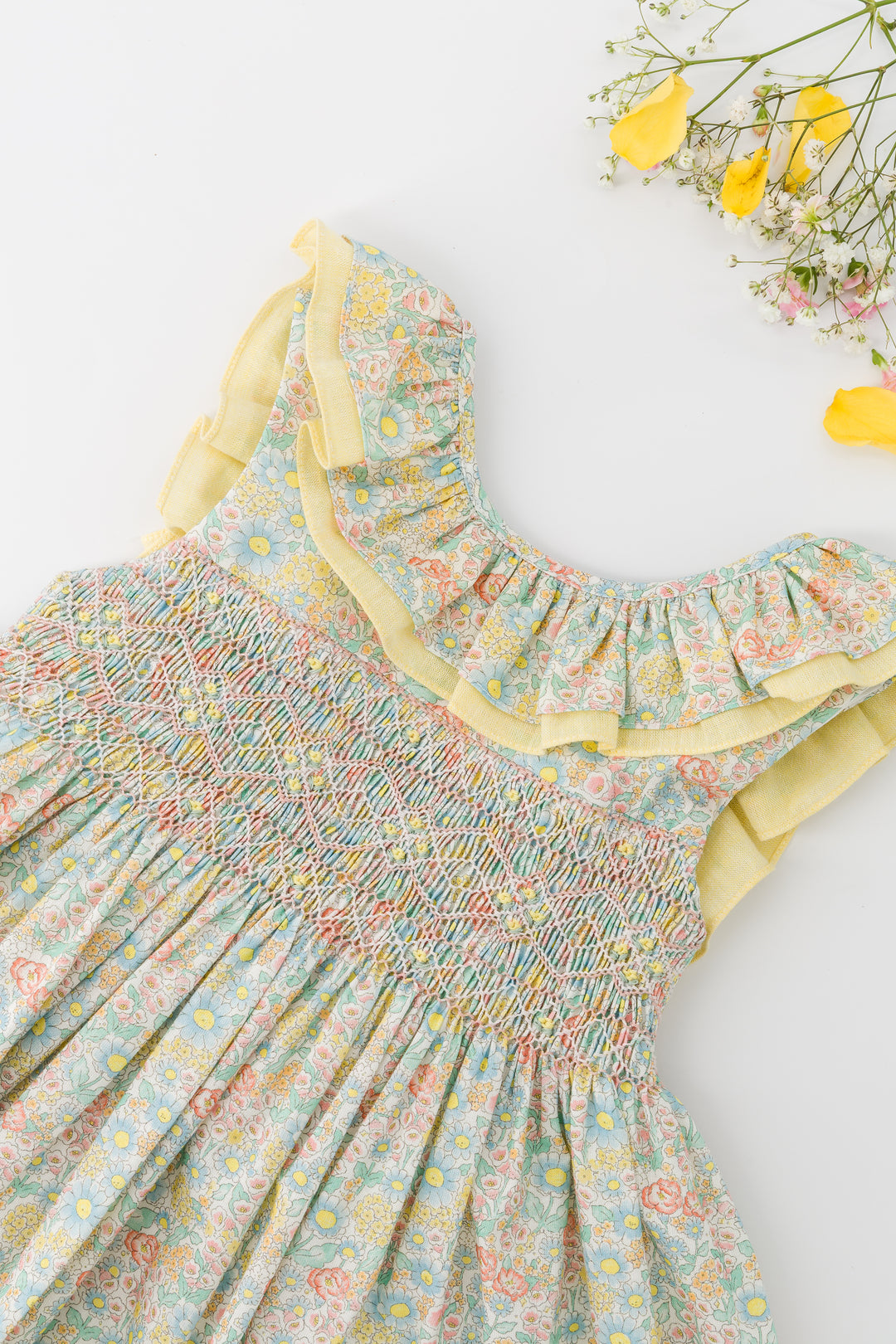 Floral dress with ruffled details on a white background