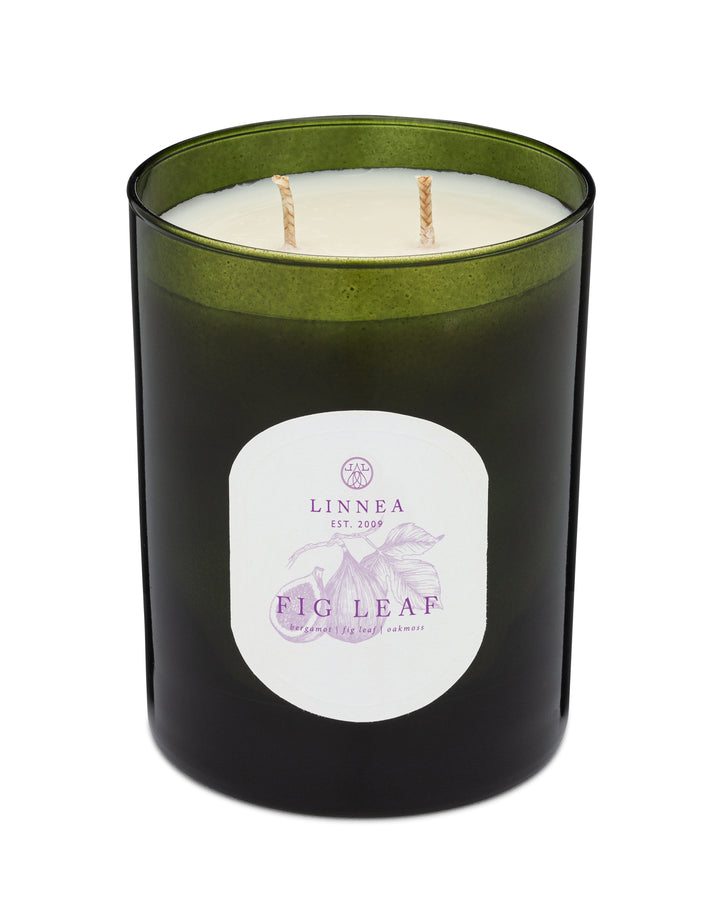 Candle with a green lid and 'LINNEA' label on a white background