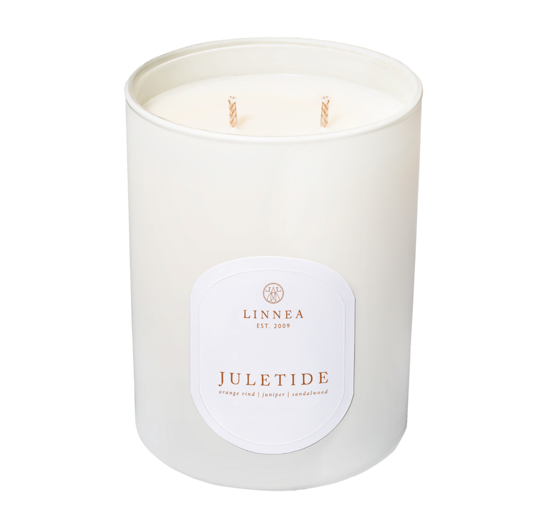 White candle with a label on a white background