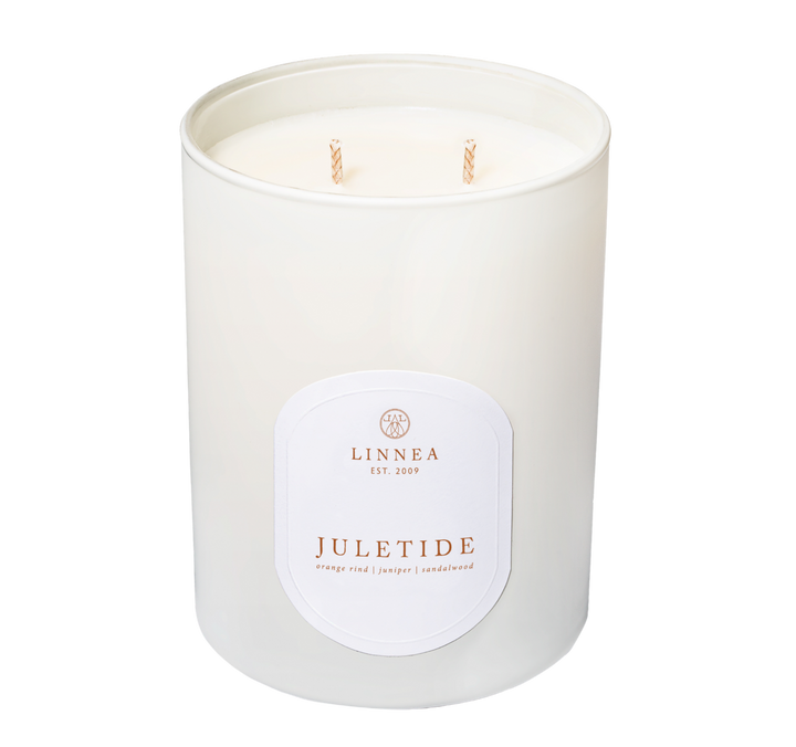 White candle with a label on a white background