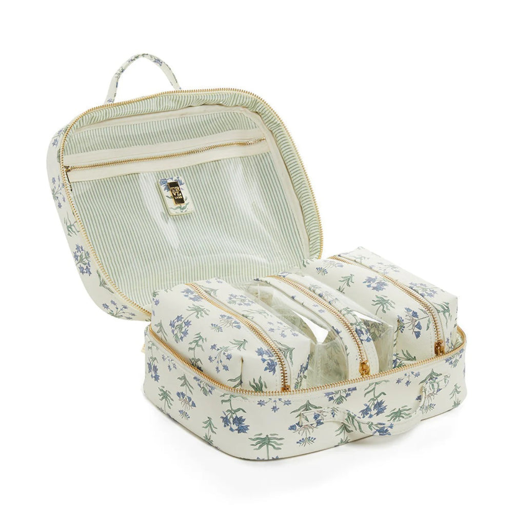 Floral-patterned toiletry bag with multiple compartments on a white background