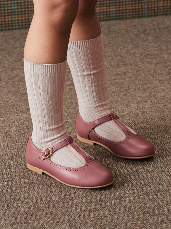 girl wearing knee high pale pink socks