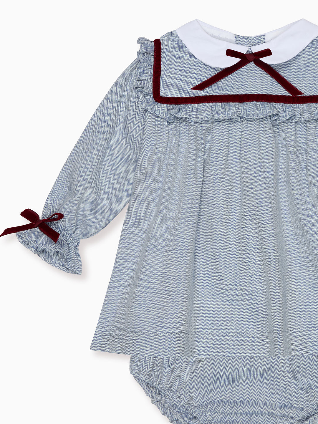 Baby dress with ruffled collar and sleeves on a white background