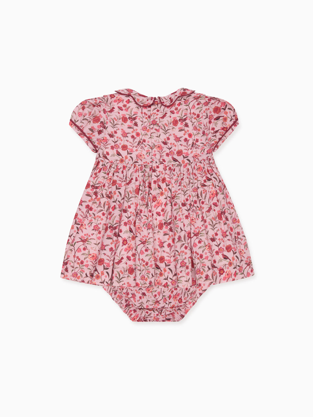 A baby romper in a pink and red floral print with a ruffled collar, short puff sleeves, and a smocked waist, shown flat on a white background.