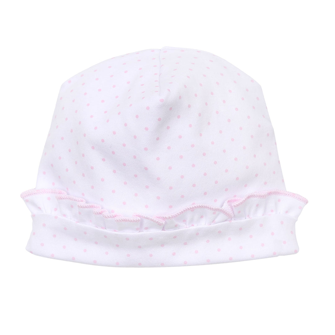 White baby hat with pink ruffle trim on a white background