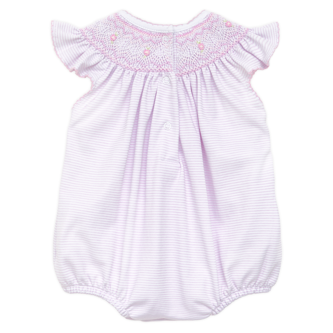 Baby romper with smocked details on a white background
